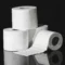 High-quality close-up image of stacked toilet paper rolls against a black background.